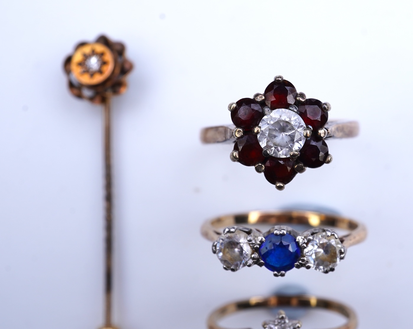 A group of three rings and a tie pin